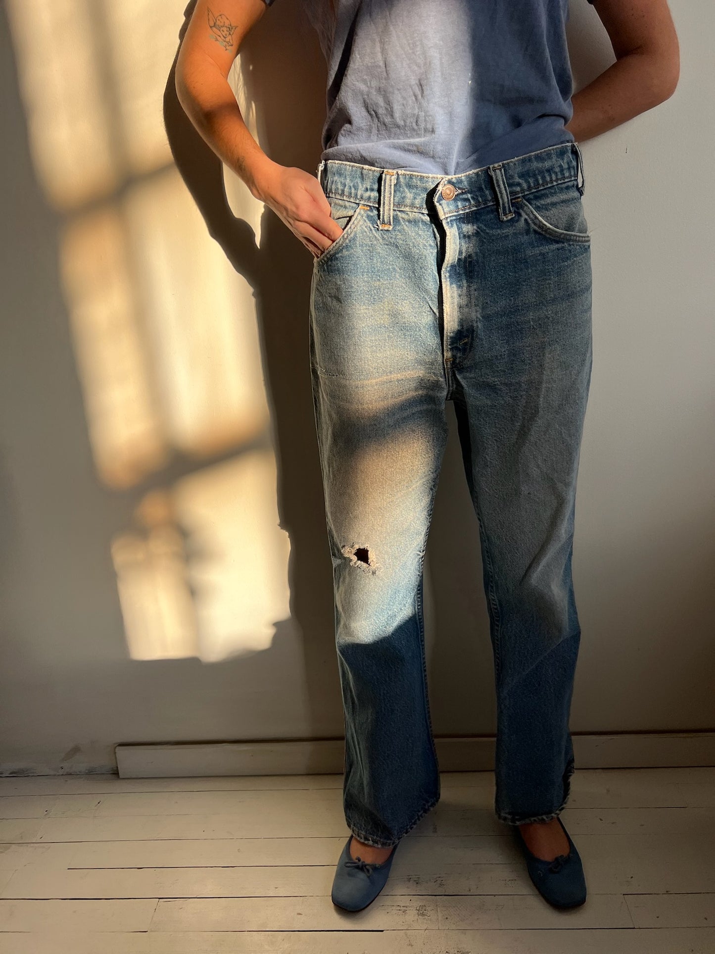 Faded and Distressed Orange Tab Levi’s