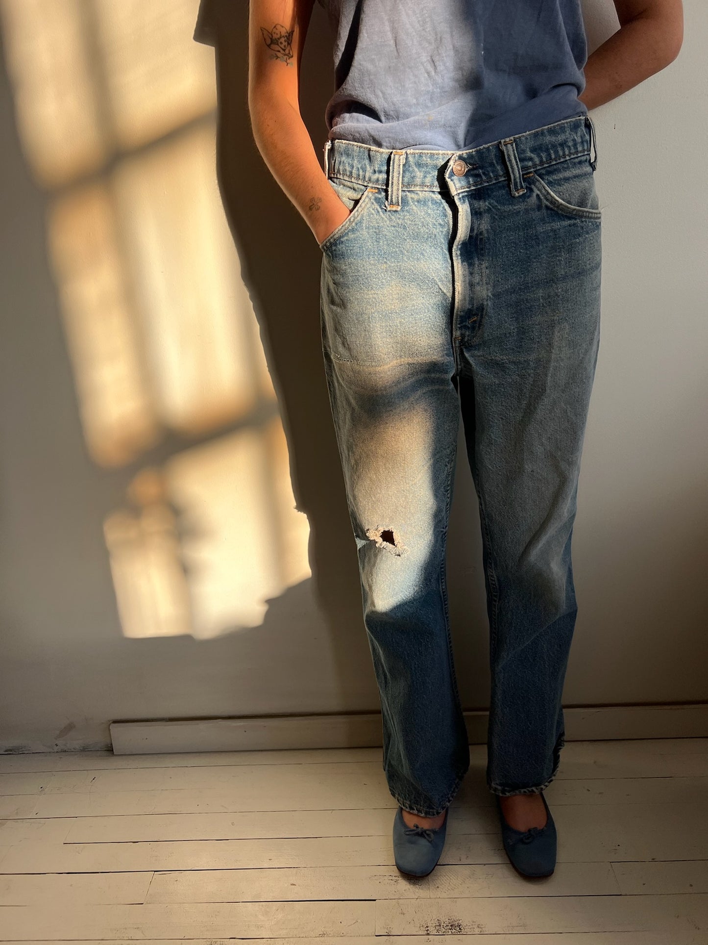 Faded and Distressed Orange Tab Levi’s